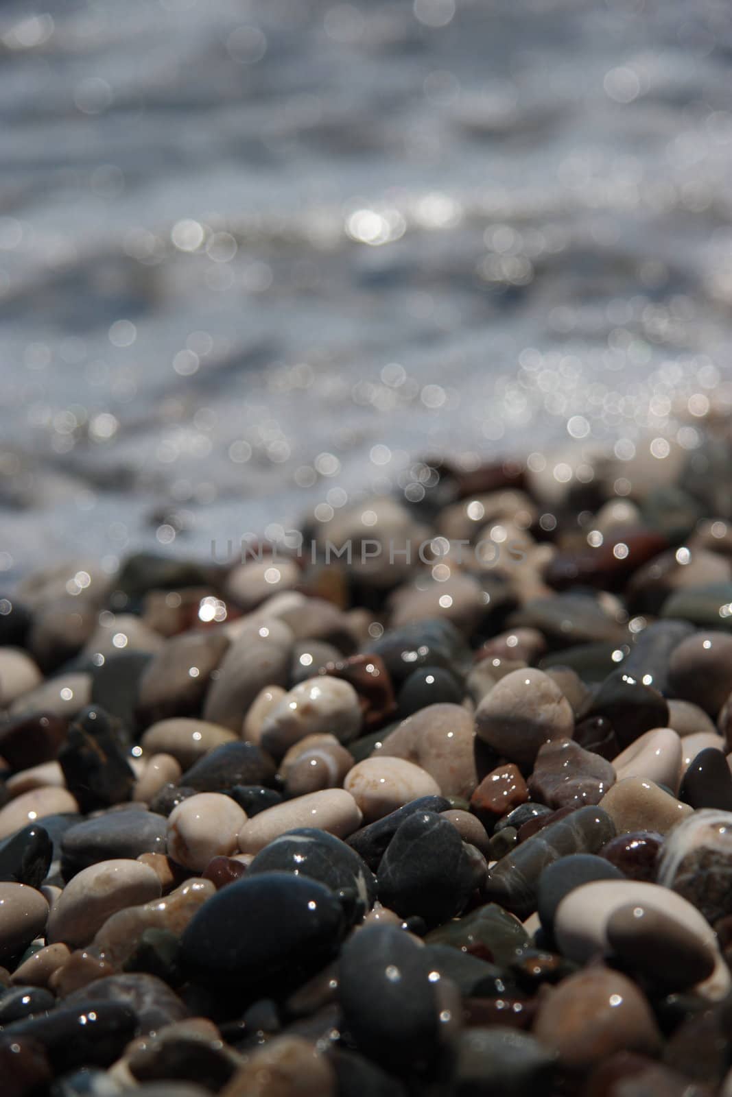 Wet pebbles on sea coast