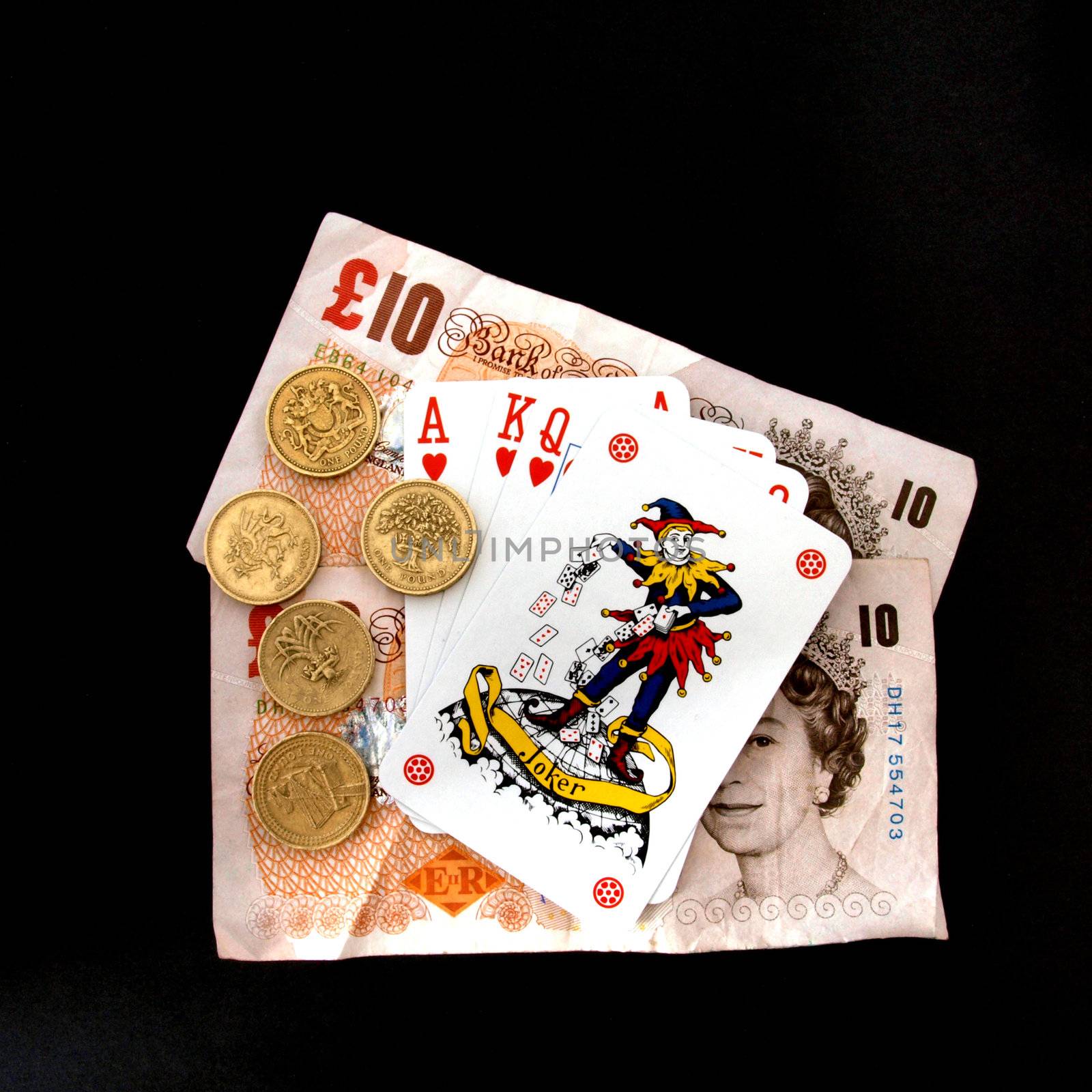 Concept of gambling showing coins, the joker  playing cards.