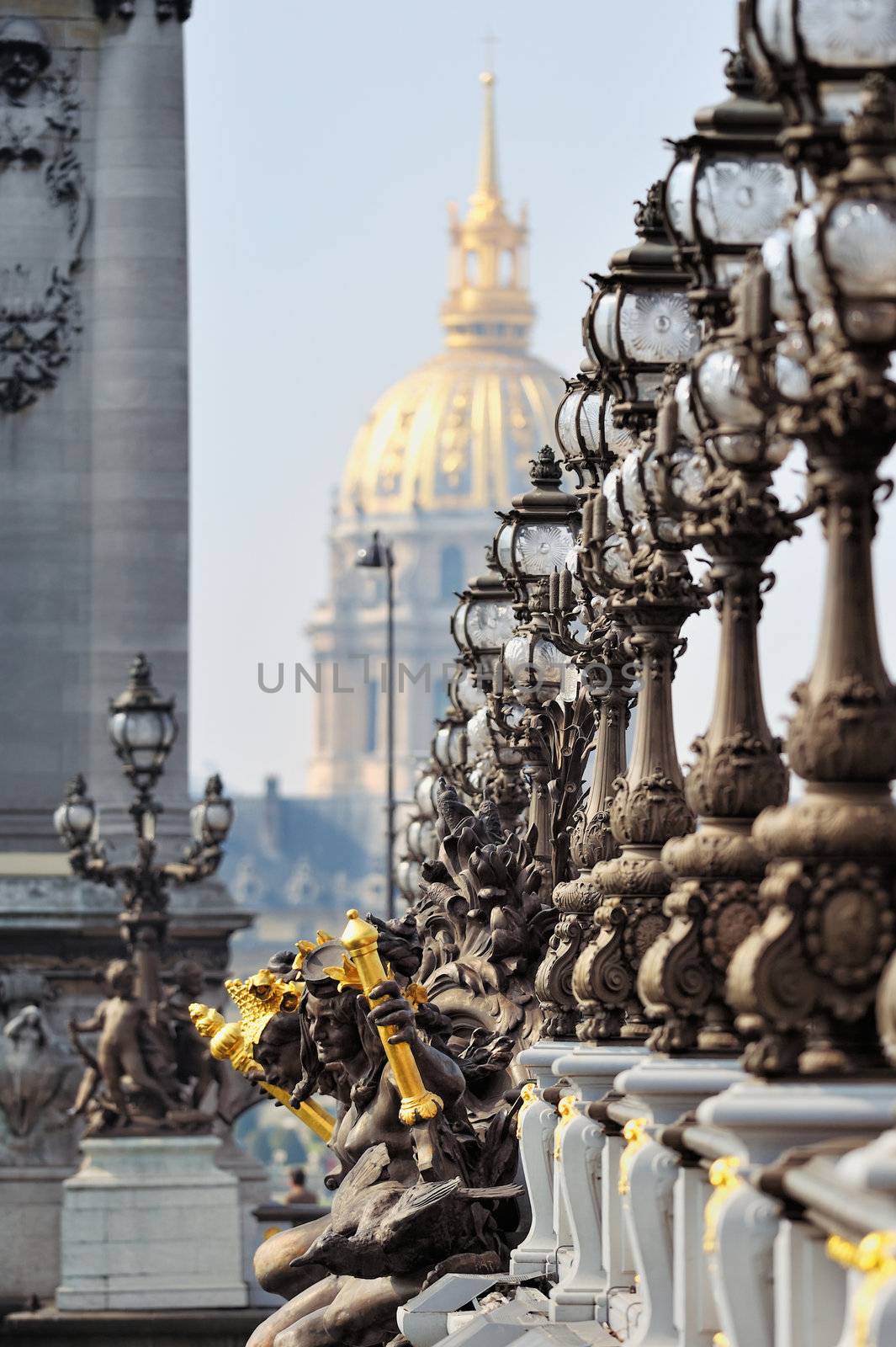 Lampposts on the bridge and the golden Dome of the Cathedral