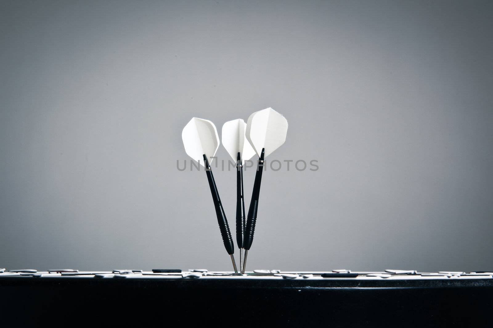 Perspective View Of Three Arrows In The Center Of Darts Board