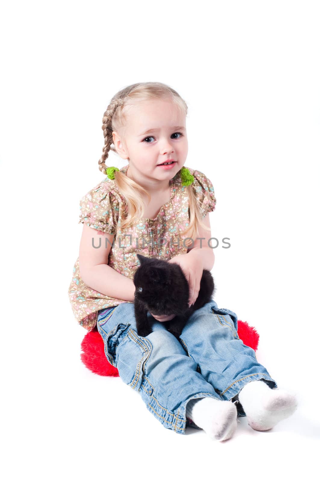 Shot of little girl playing with kitten