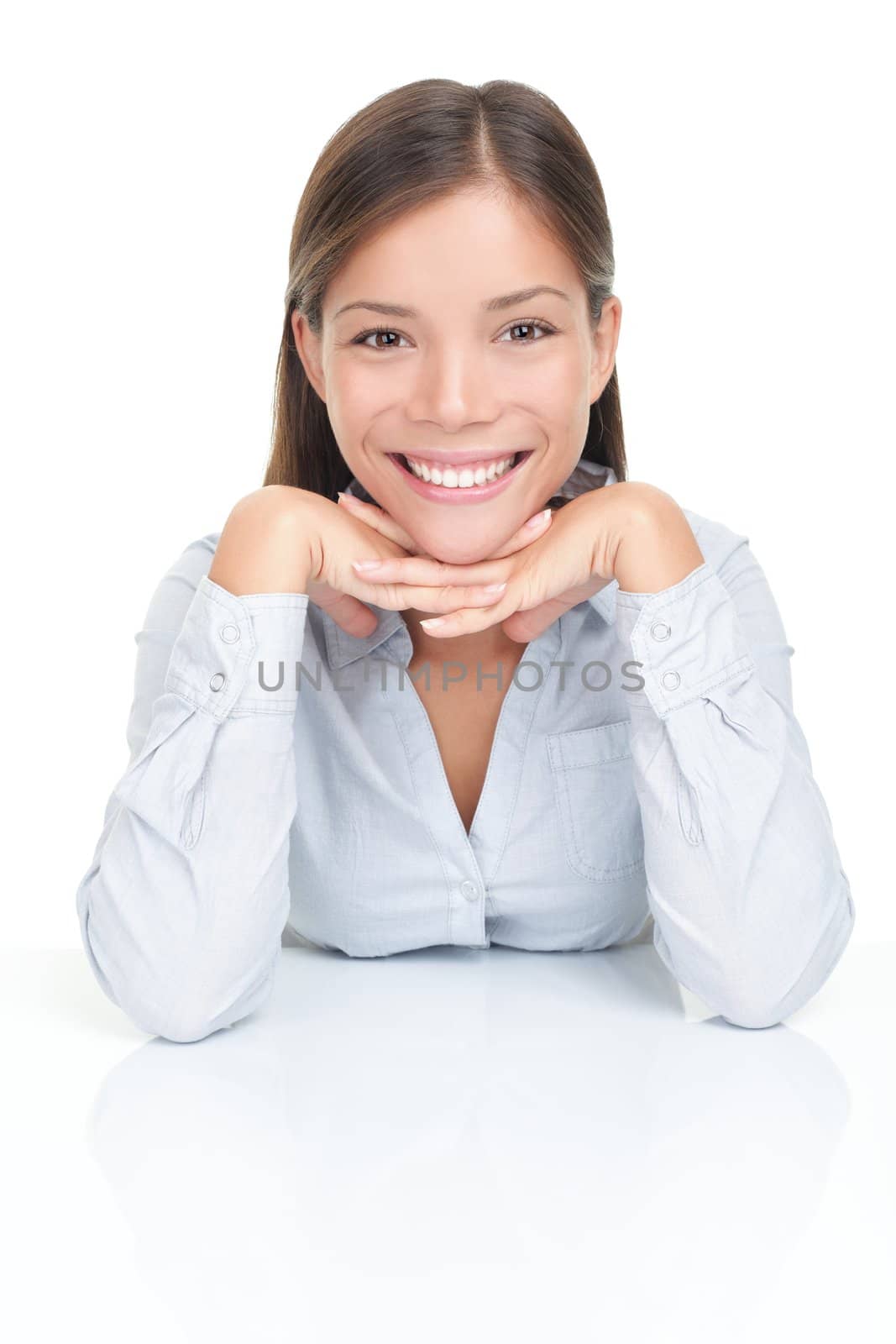 Young woman smiling sitting at table by Maridav