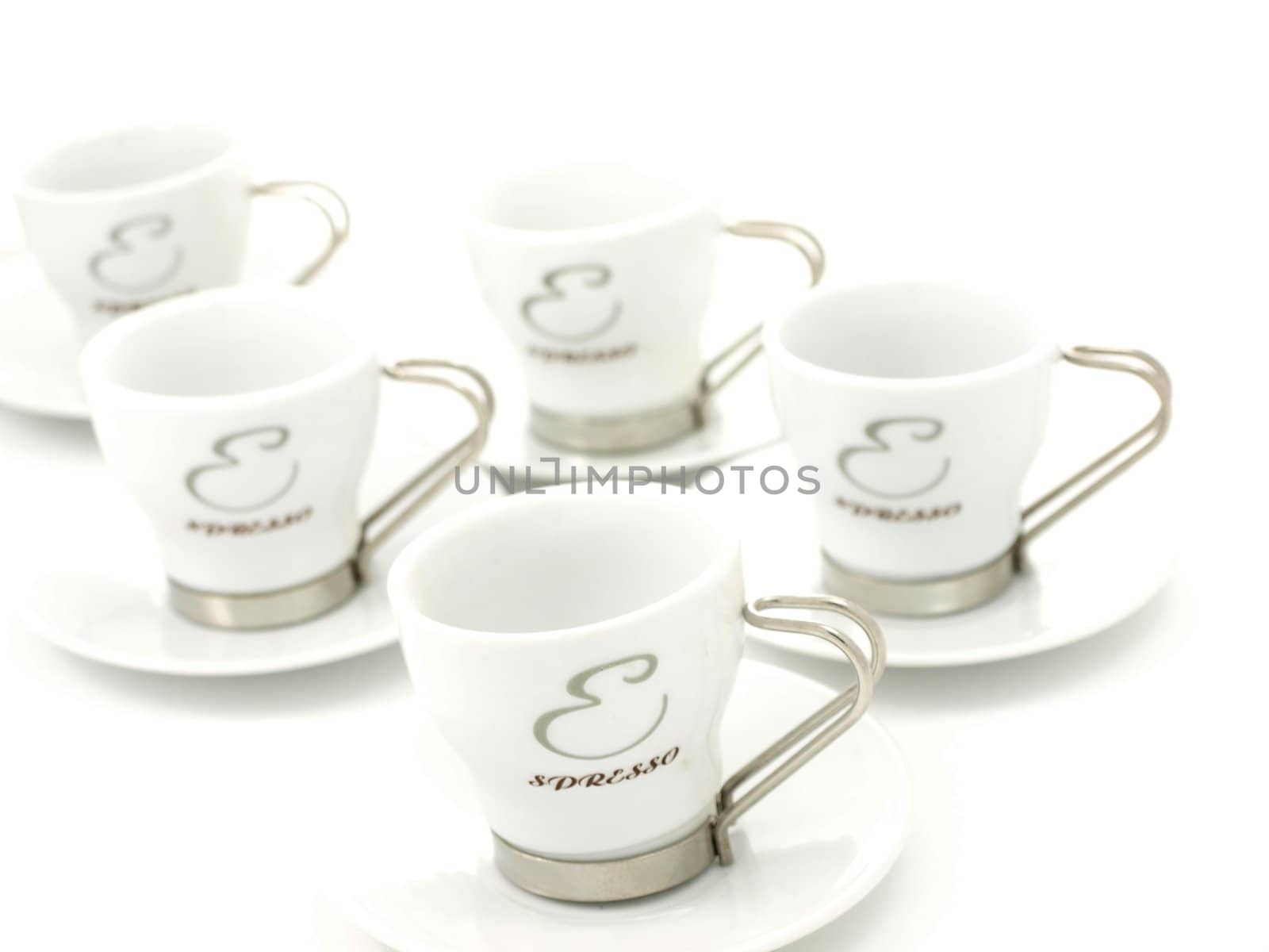 Espresso coffee cups, on plates, towards white