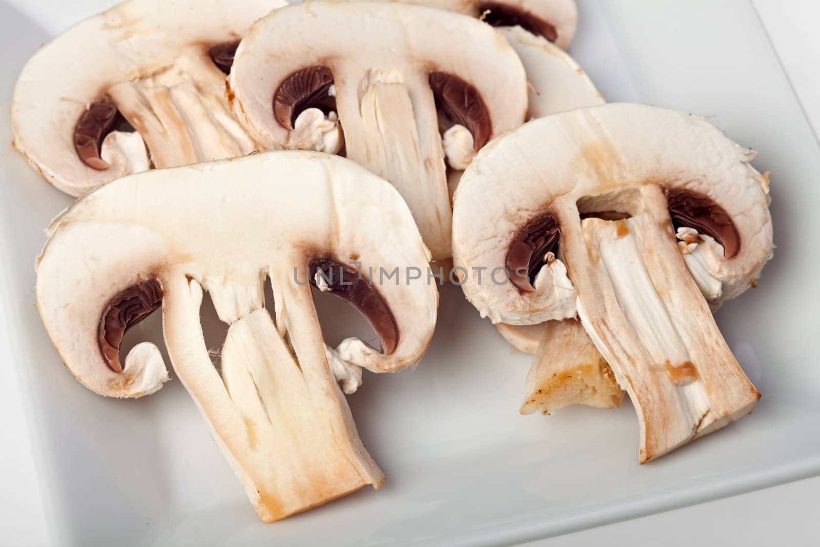 slices champignon mushrooms on white background