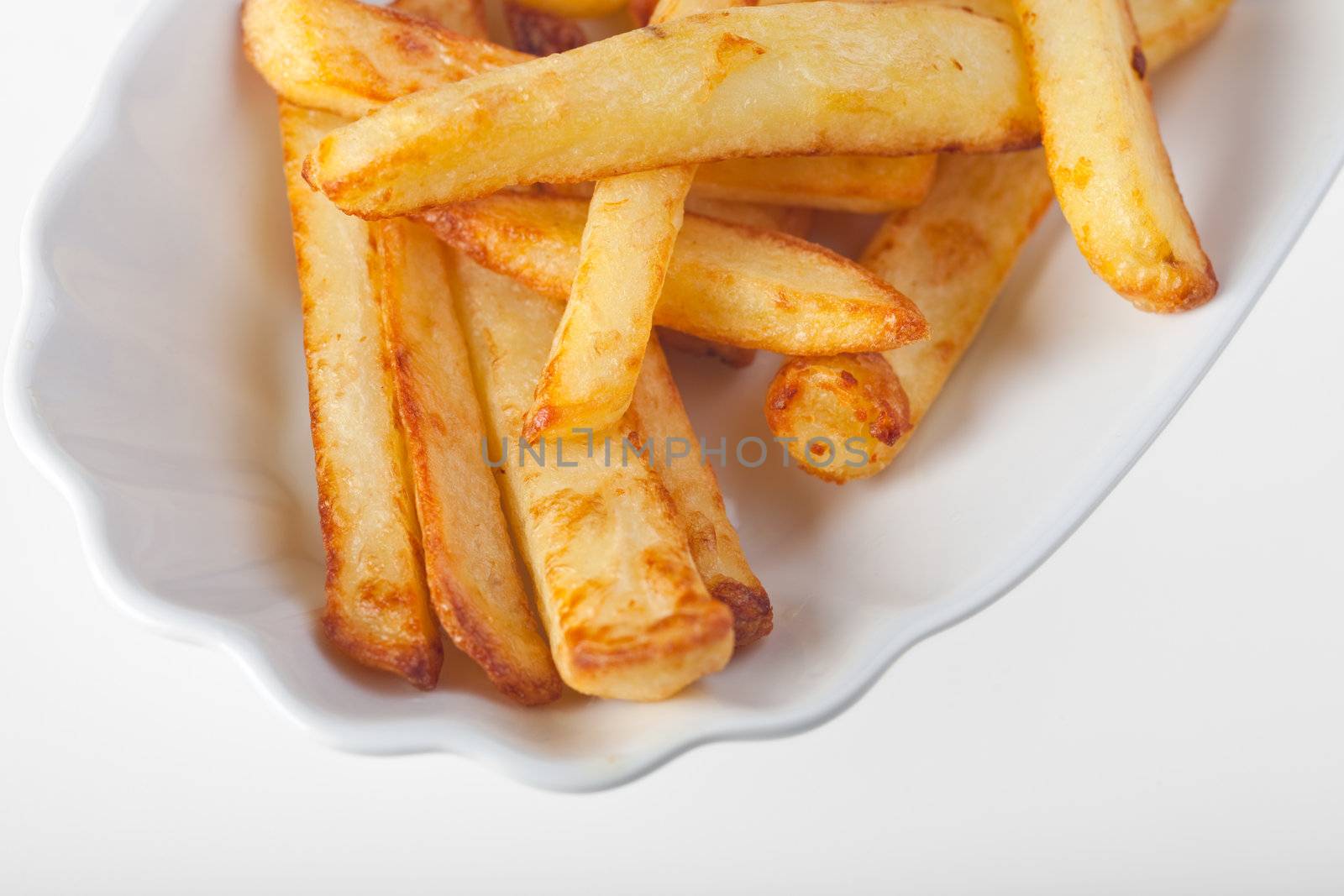 french fries on a typical plate by bernjuer
