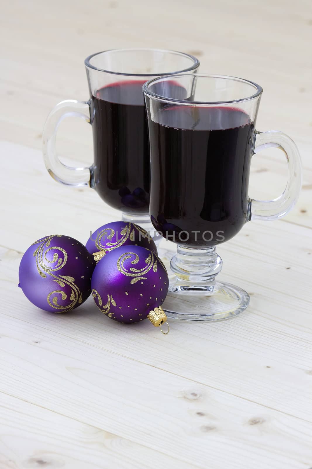 two glasses of hot wine and christmas balls