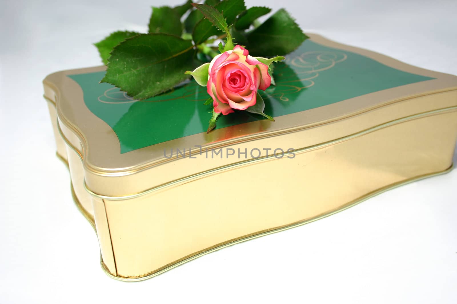rose on a tin of chocolates over a light background