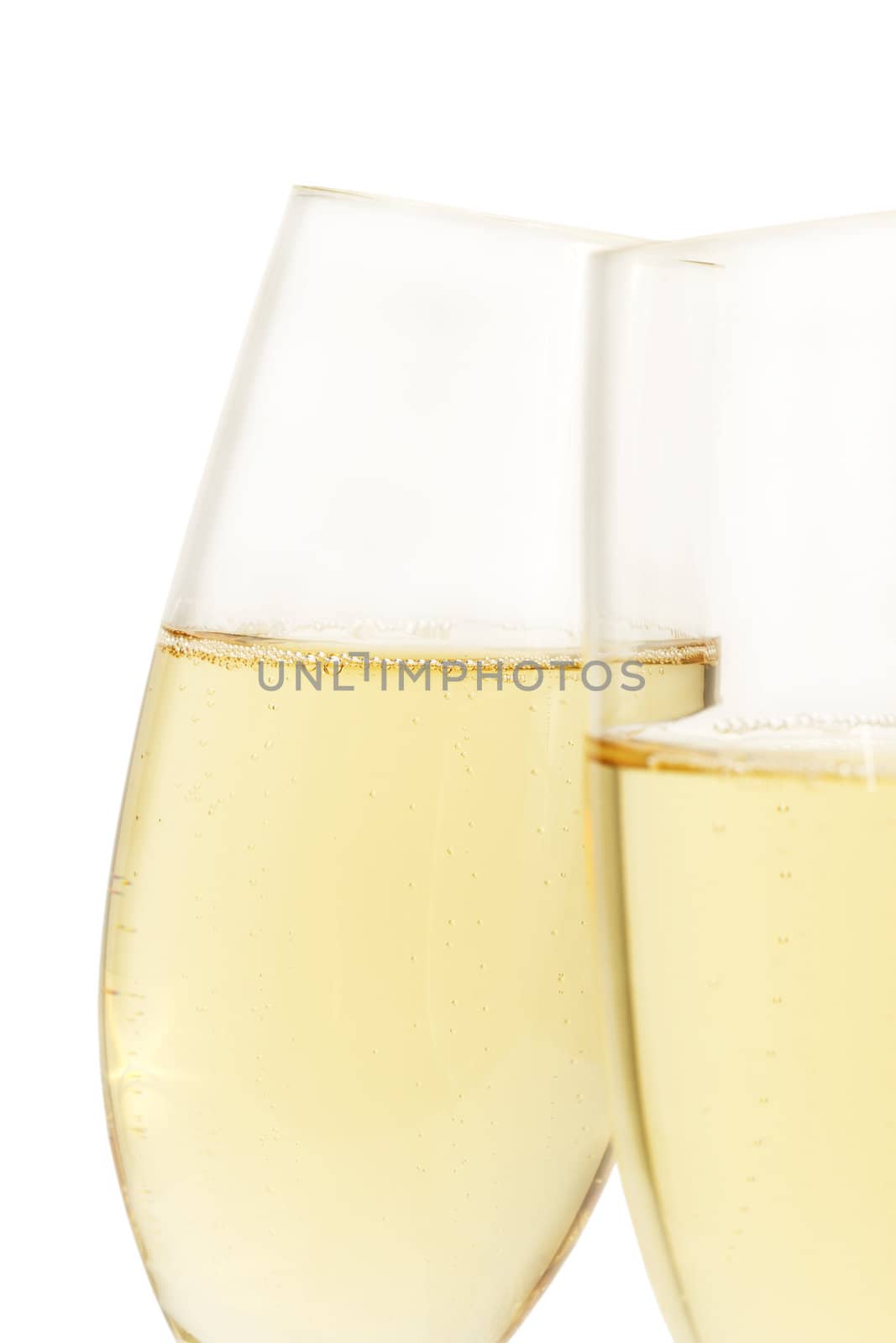 aslope glass of champagne behind other on white background