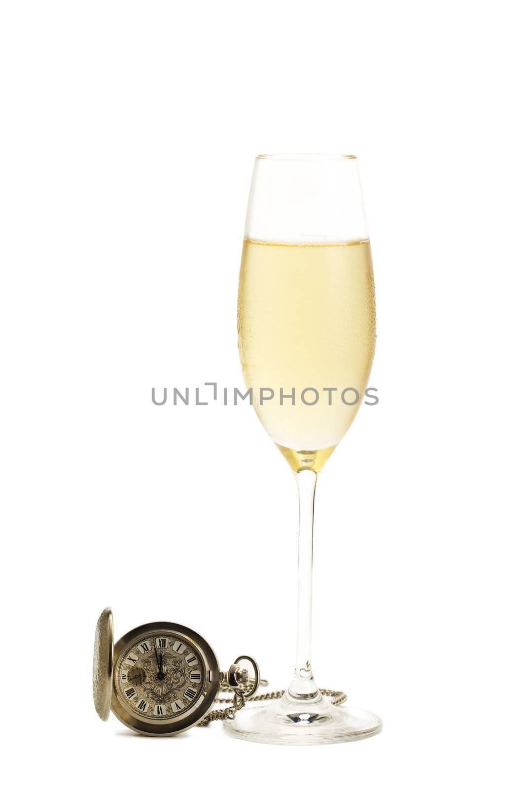 cold glass of champagne with a old pocket watch on white background