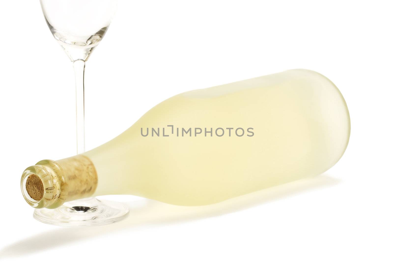 lying dull prosecco bottle with a empty champagne glass on white background