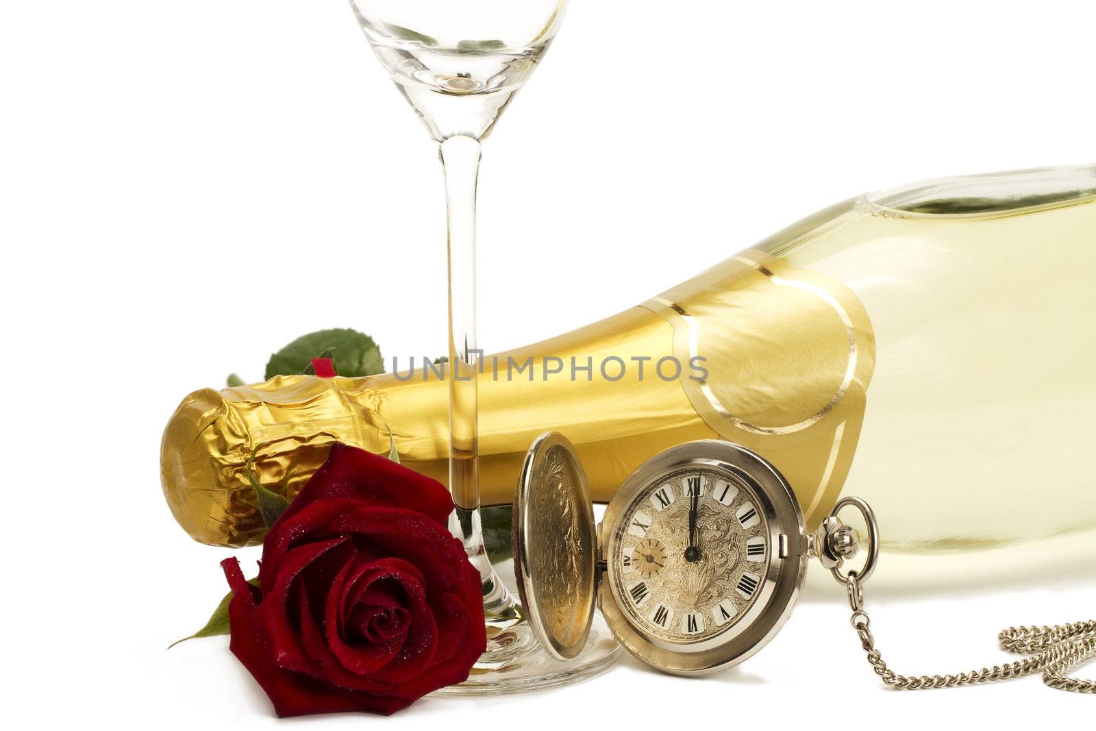 wet red rose under a champagne bottle with a old pocket watch and a empty champagne glass on white background