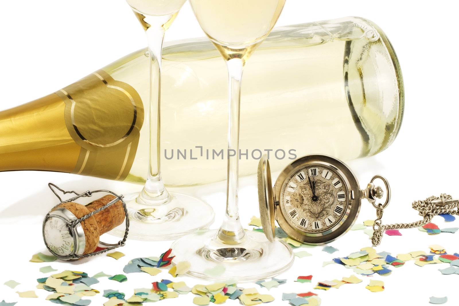 two glasses with champagne, old pocket watch, cork and confetti in front of a champagne bottle on white background