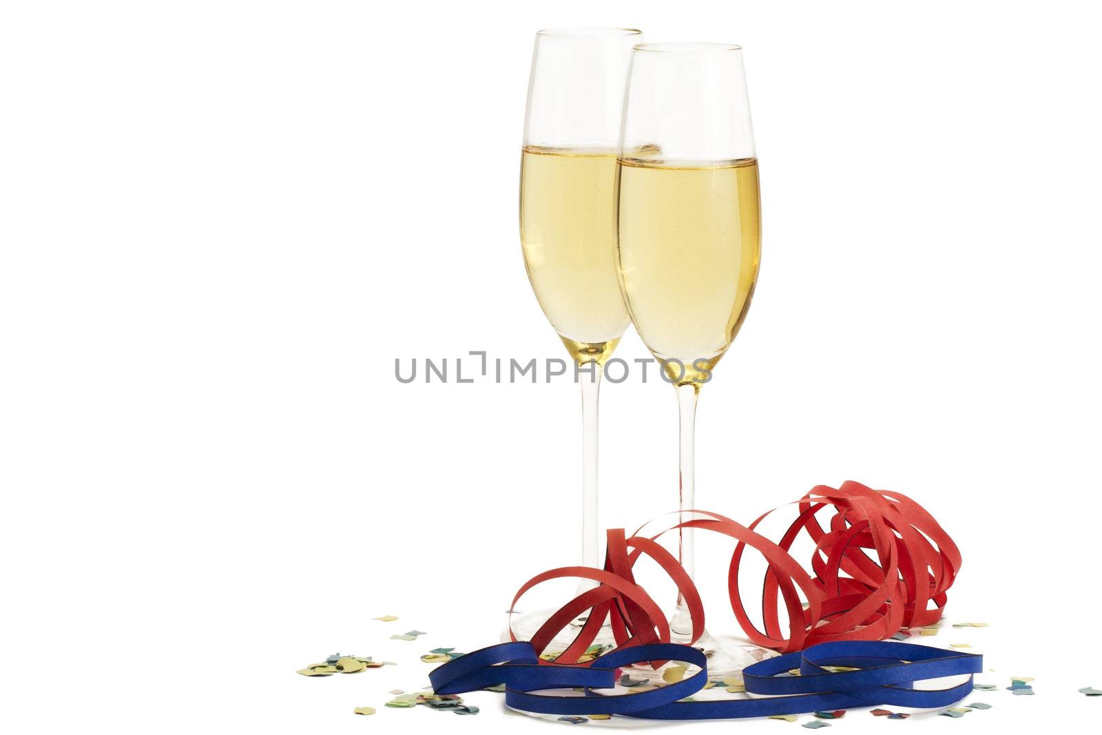 two champagne glasses with blow-outs and confetti on white background