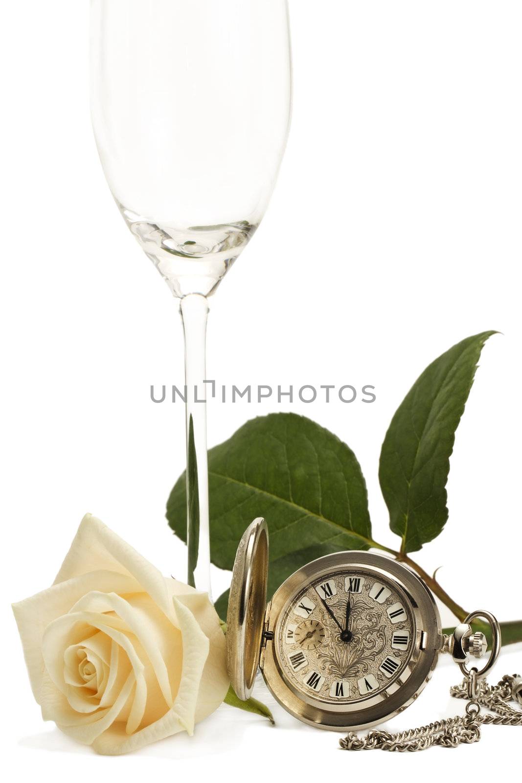 creamy rose with a old pocket watch and a empty champagne glass on white background