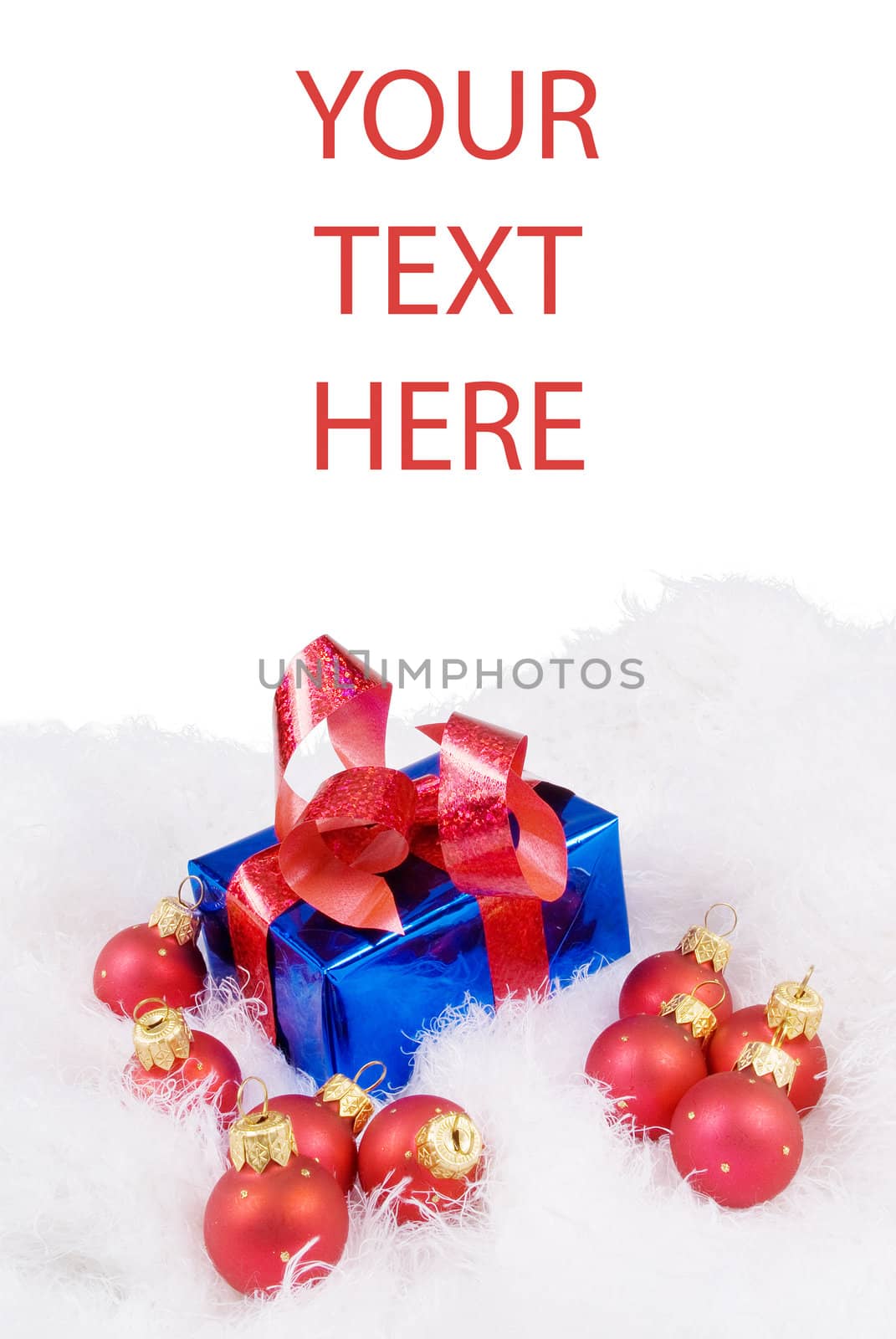 Christmas card with red spheres and blue box on the white fur