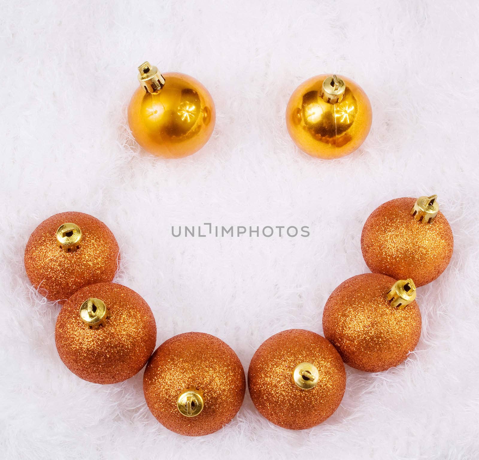 Christmas golden brightly spheres on the white fur