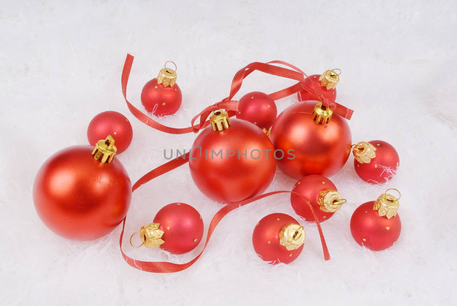 Red spheres with ribbon on the white fur