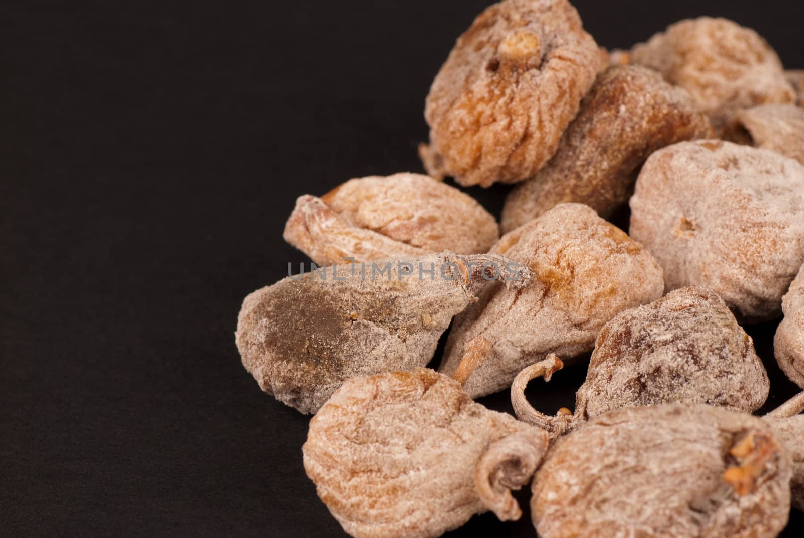A heap of dried figs with copy space