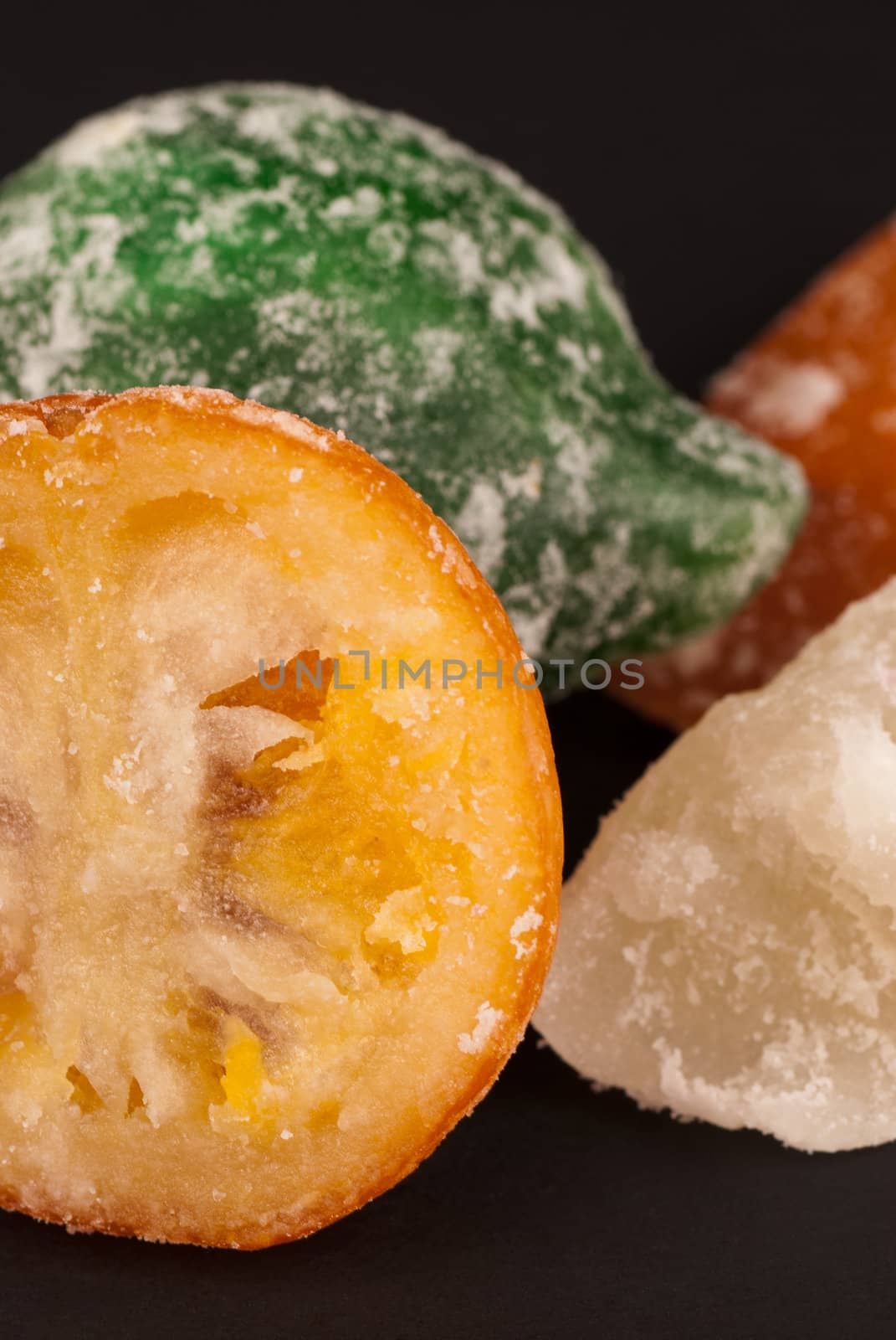 Closeup of assorted candied fruit on black