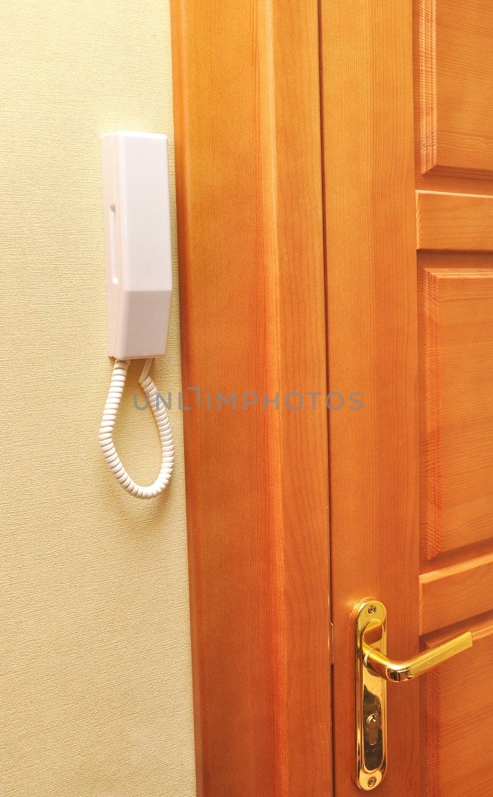 intercom phone with a button near the door