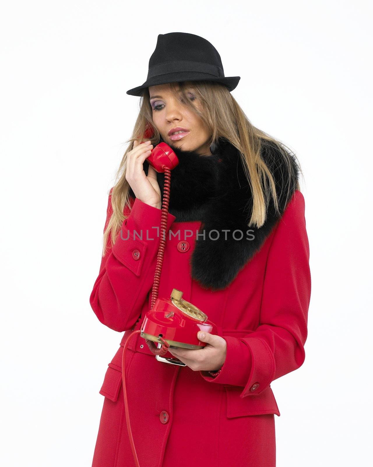 Young woman on old red phone