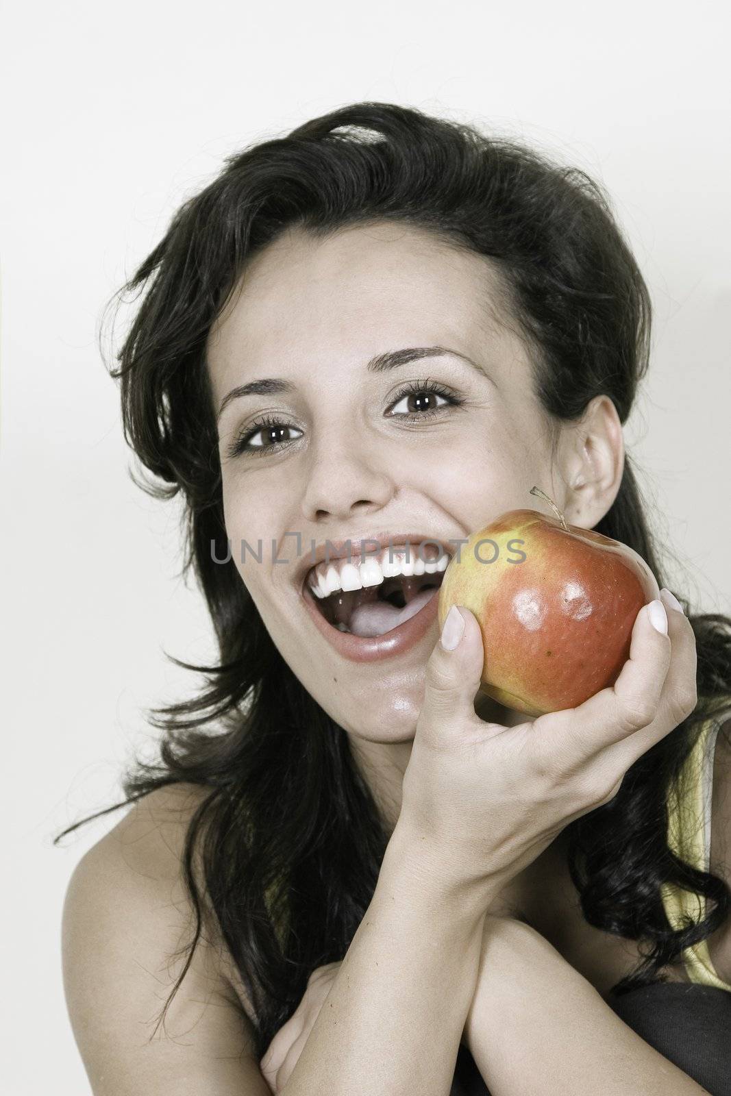Young happy smiling woman with red apple by VictorO