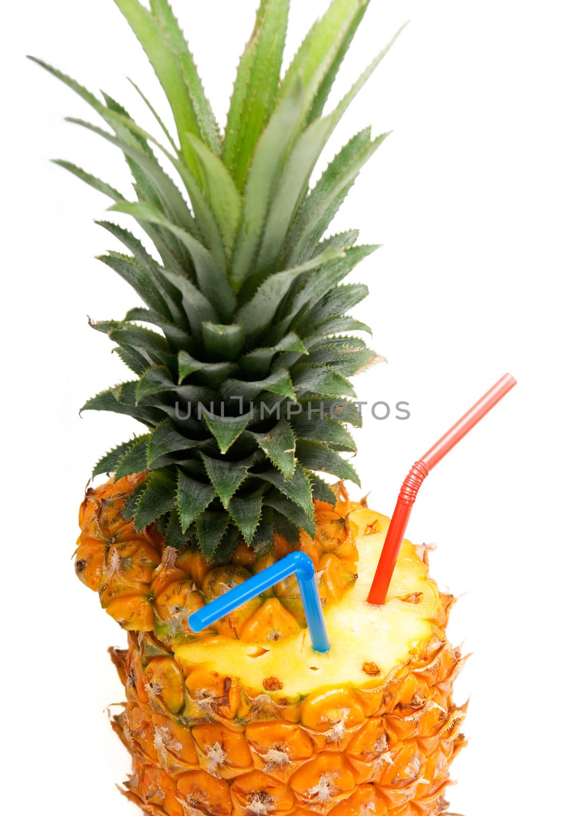 ripe pineapple cutted on top with red and blue straws isolated on white background