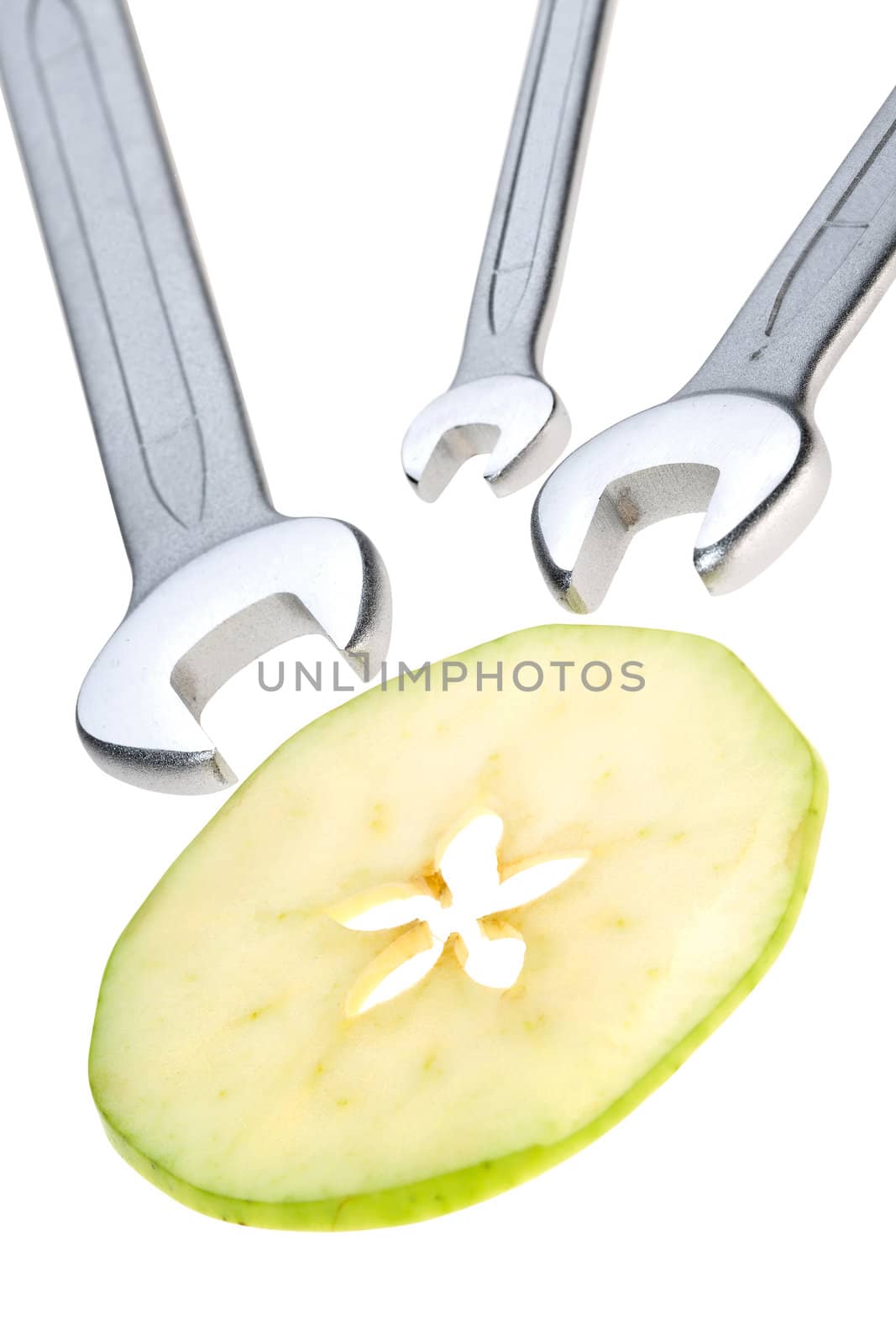 Cut apple and wrench isolated. Clipping path