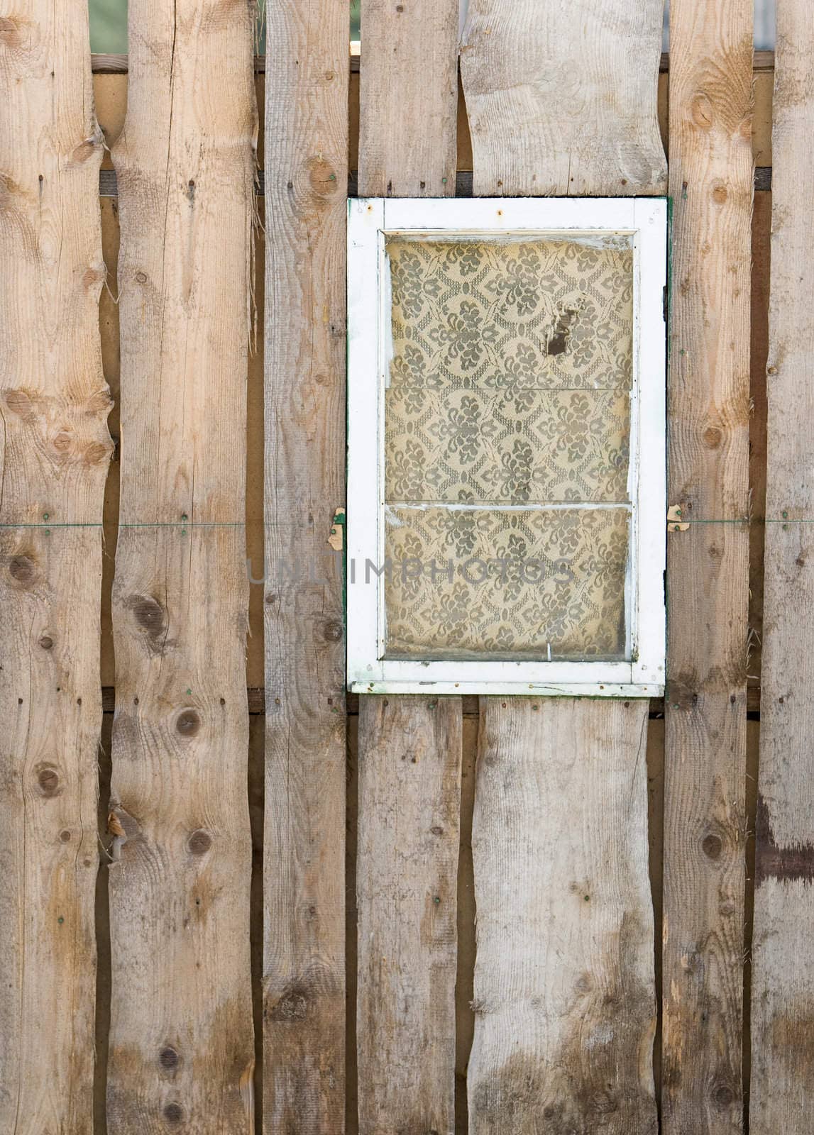 Old boarded pine wall with white window