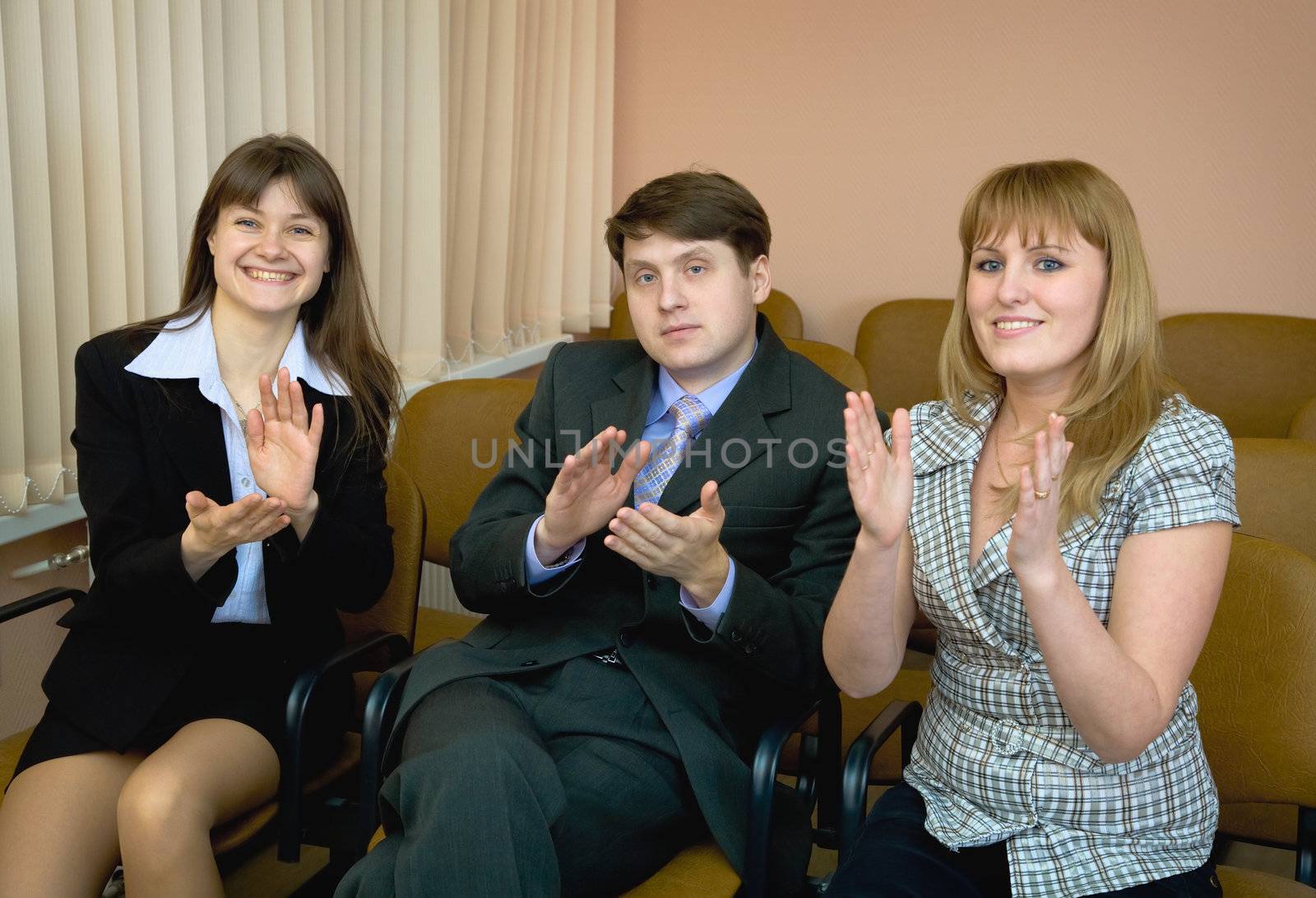 People applaud acting in a conference hall