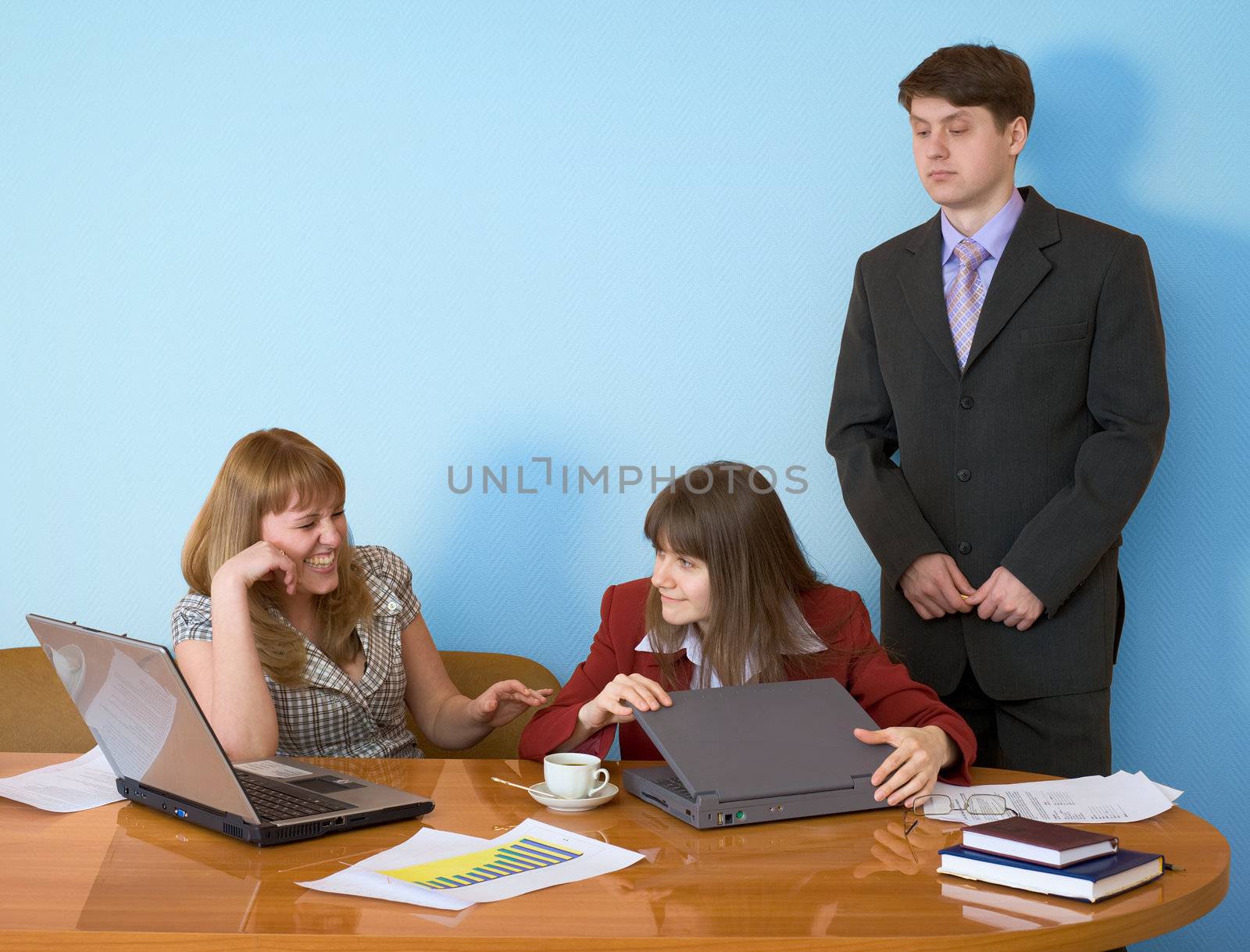 Girls sitting at a desktop and their chief