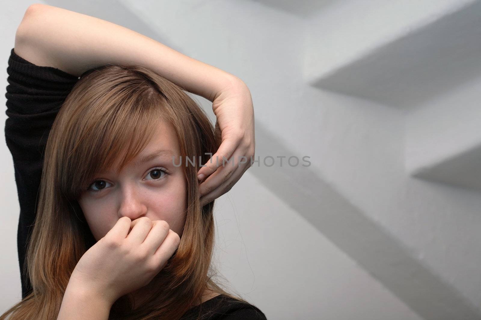 Nice young girl portrait on gray background with staircase