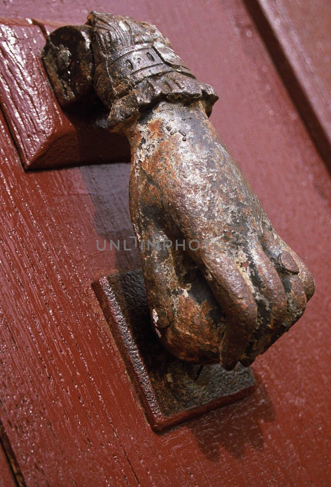 Traditional style of doorknocker on a farmhouse door in SW France