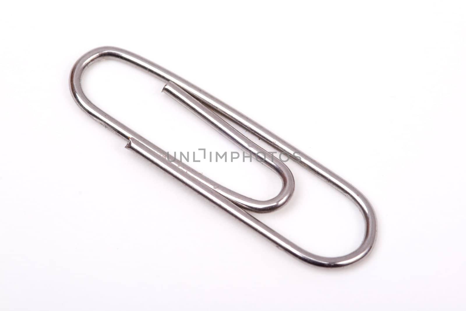 A metal paperclip on a white background