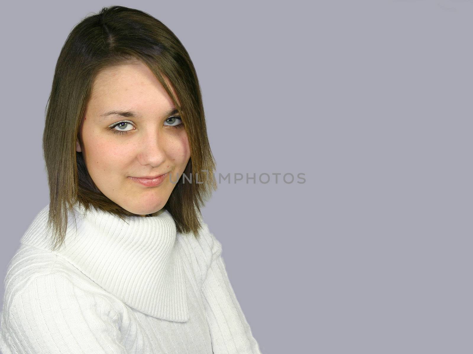 young female in a white jumper against a grey background
