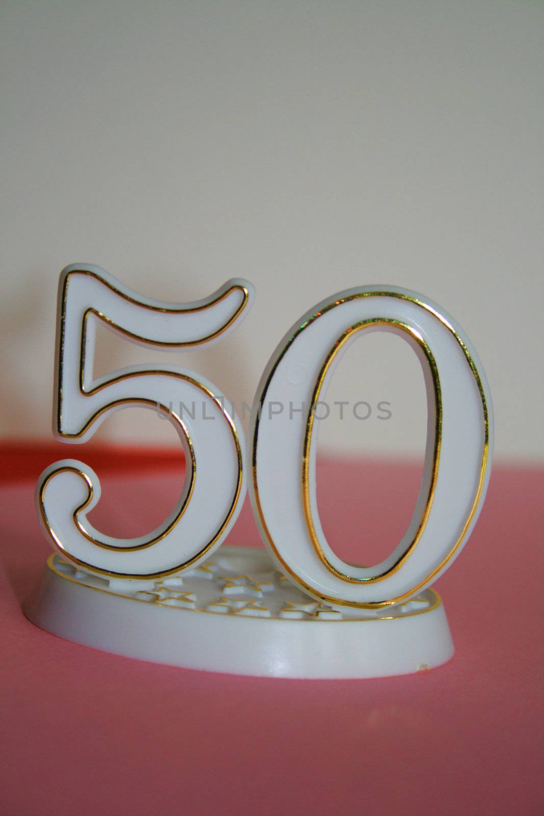 50th occasion sign over pink and white