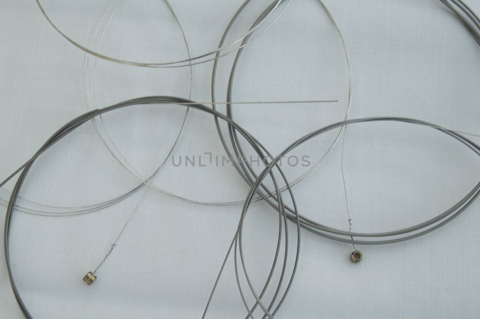 Set of Metal Guitar Strings on White background