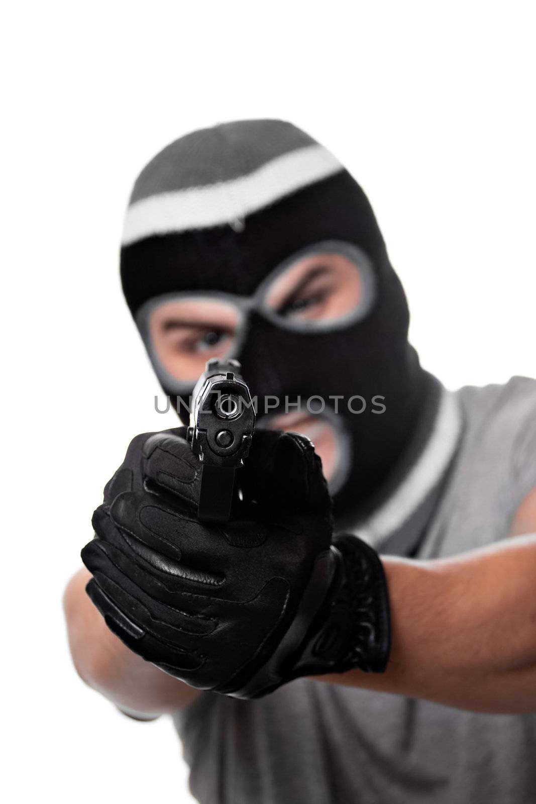 An angry looking man aiming a handgun at the viewer. Works great for crime or home security concepts.