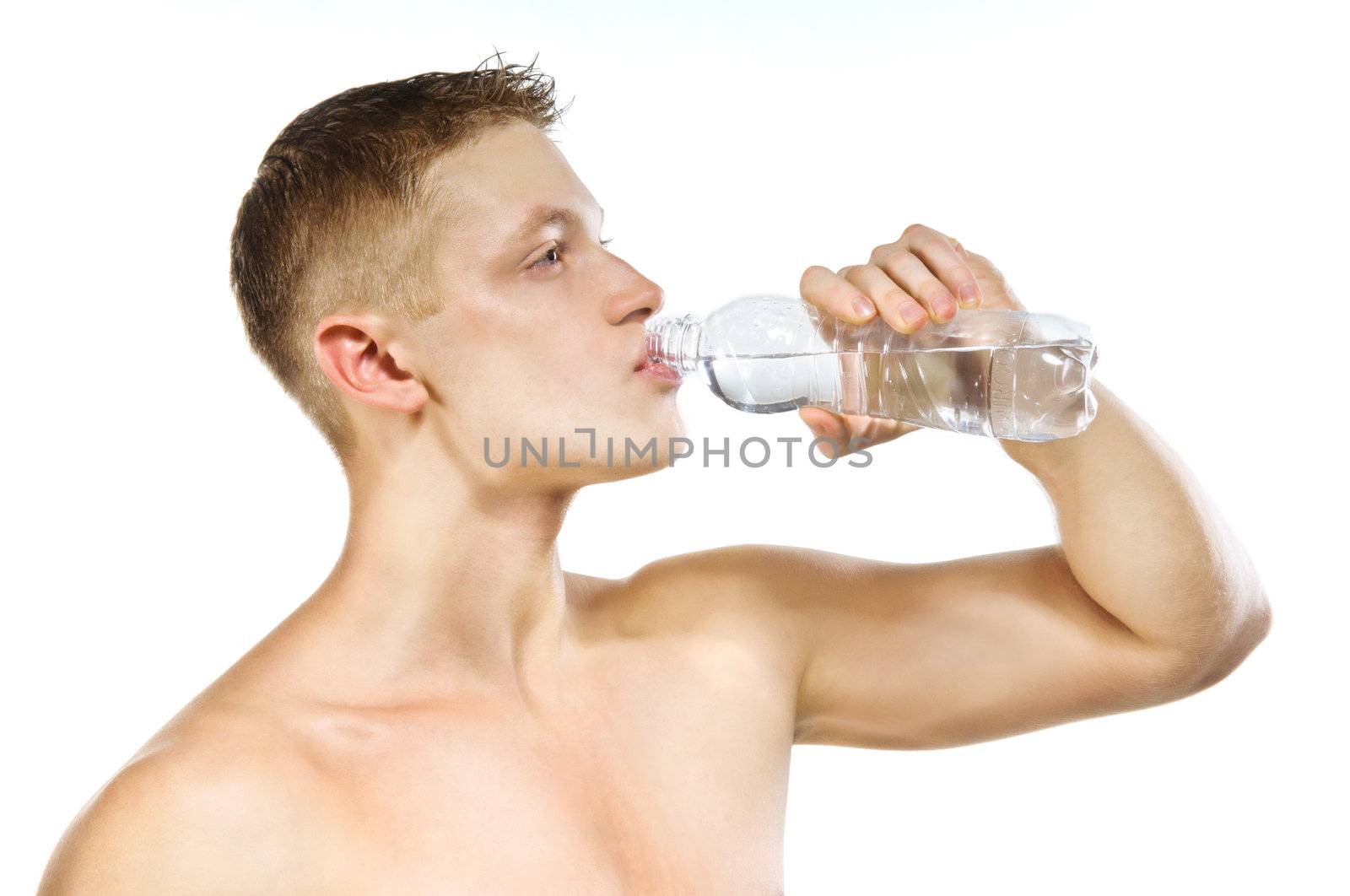 Handsome muscular male with bottle of mineral water on white background