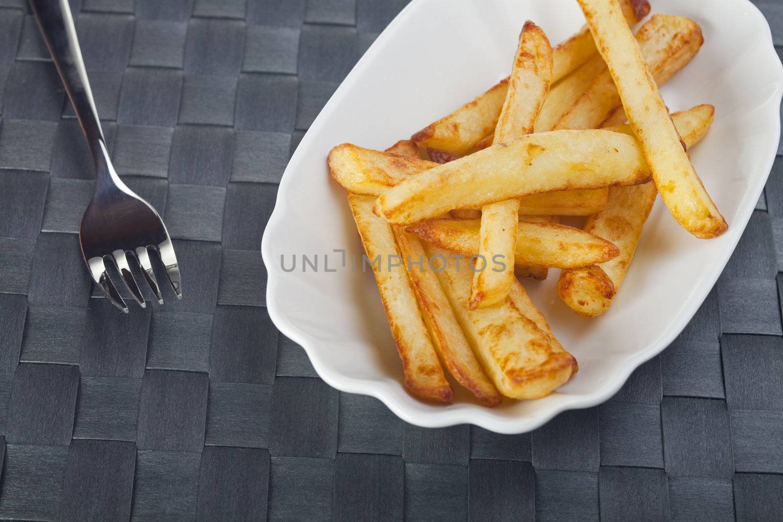 french fries on a typical plate by bernjuer