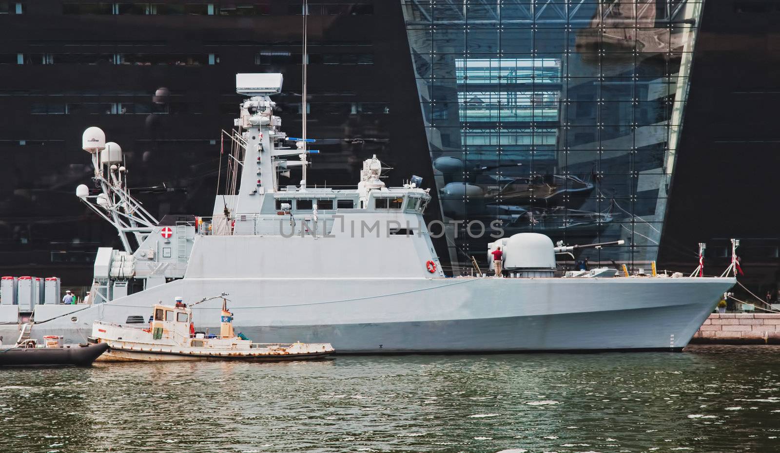 Big battleship and boats staying in the dock