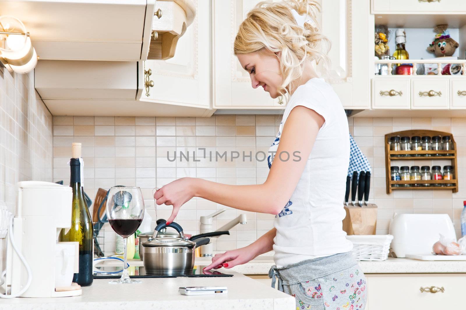 Beautiful young woman working in the kitchen