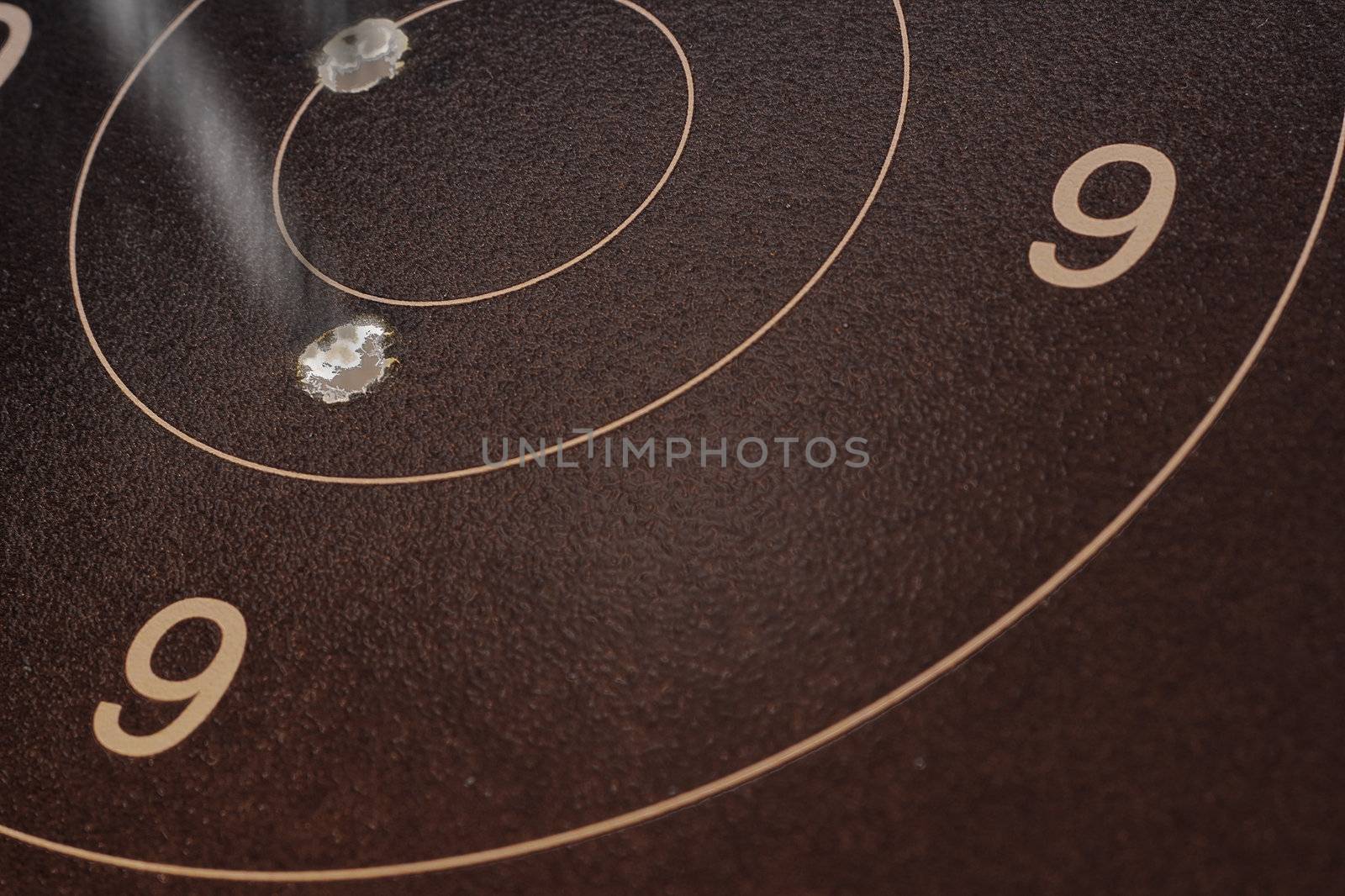 Photograph of a back-lit target sheet, showing a couple of good rounds