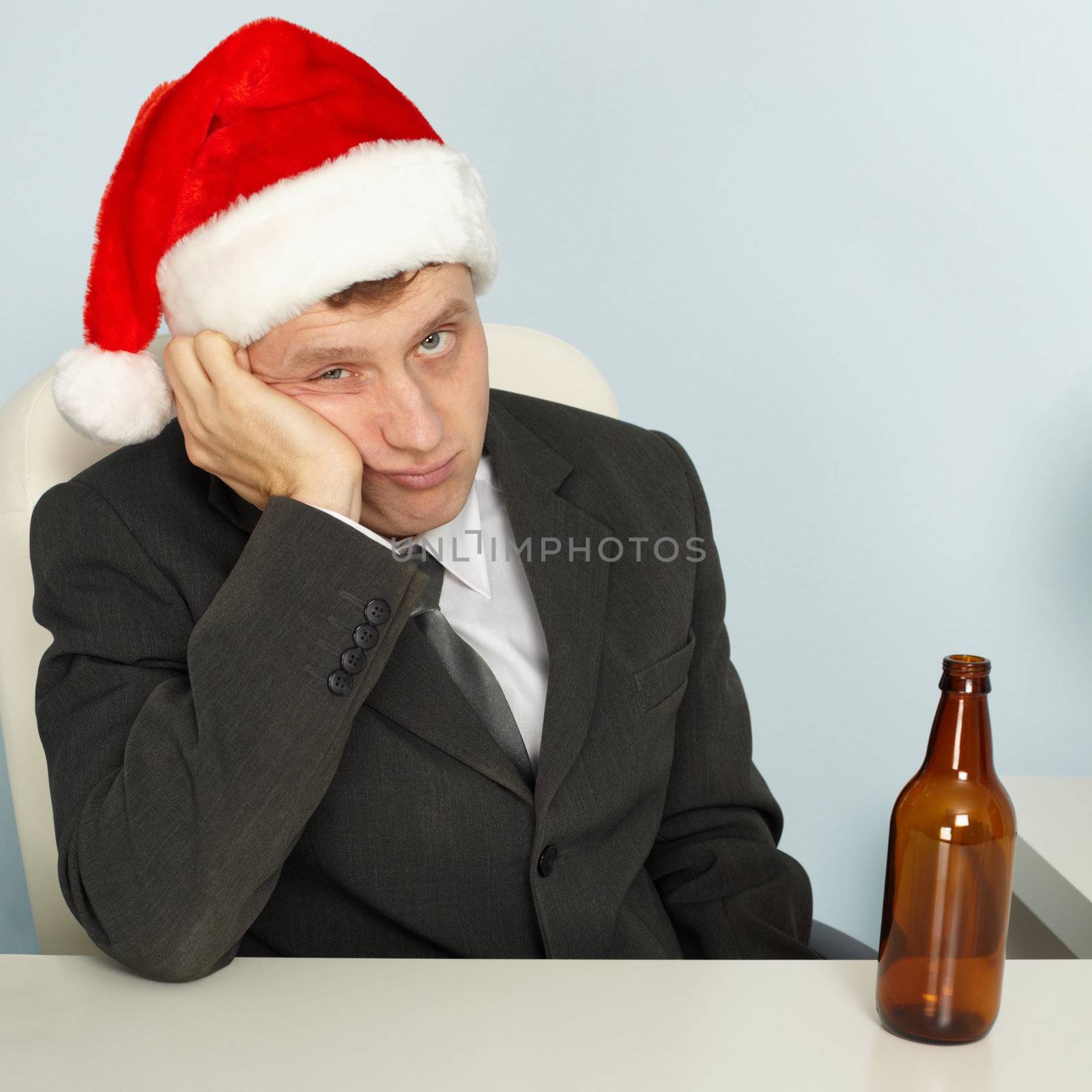 Sad man suffering from hangover after Christmas by pzaxe