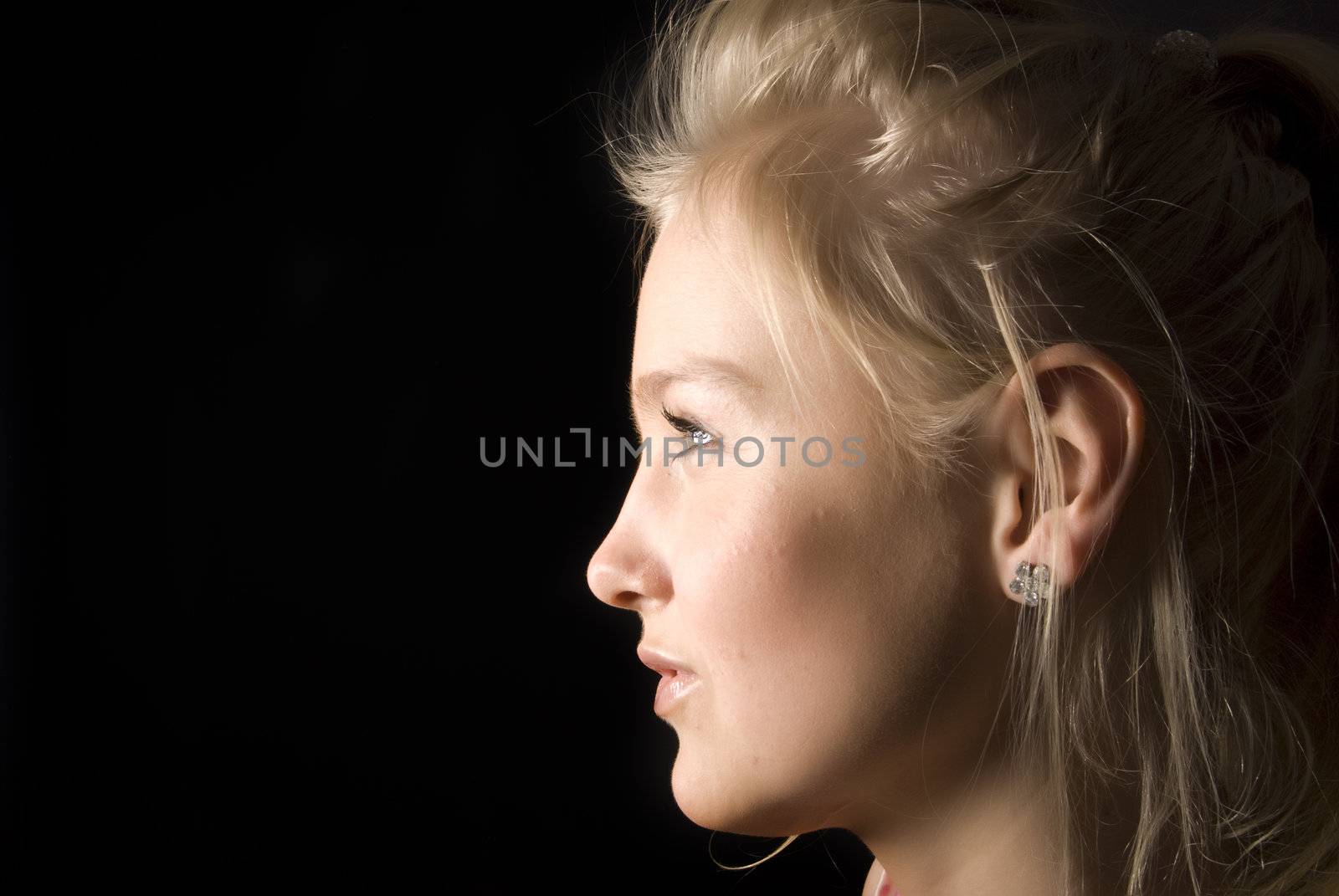 Portrait of a young seductive blonde-sideview