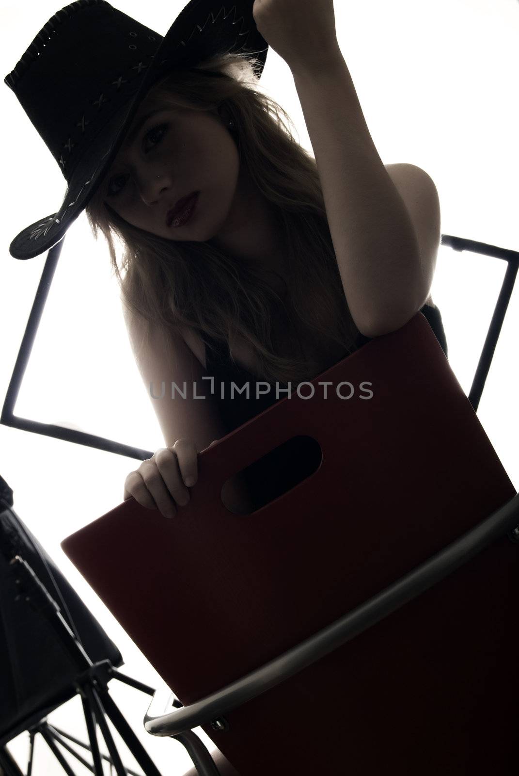 young sexy cowgirl posing indoors