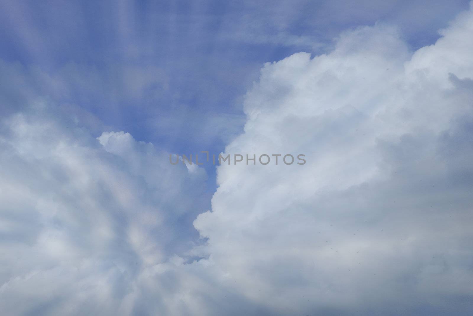 Rays of light shining through cumulonimbus clouds      