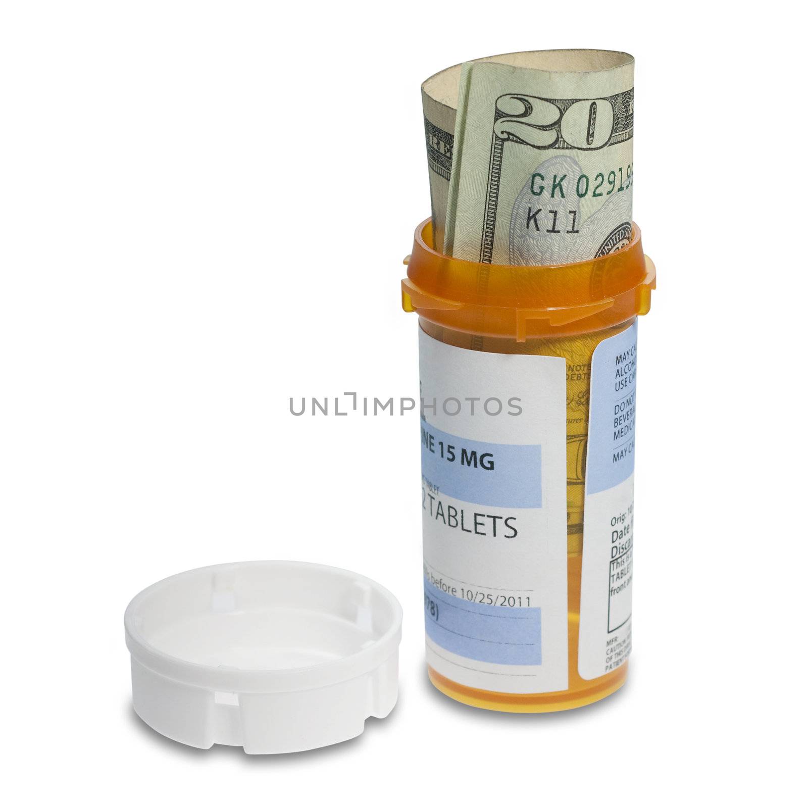 Prescription bottle with bills inside shot to illustrate the cost of medicine