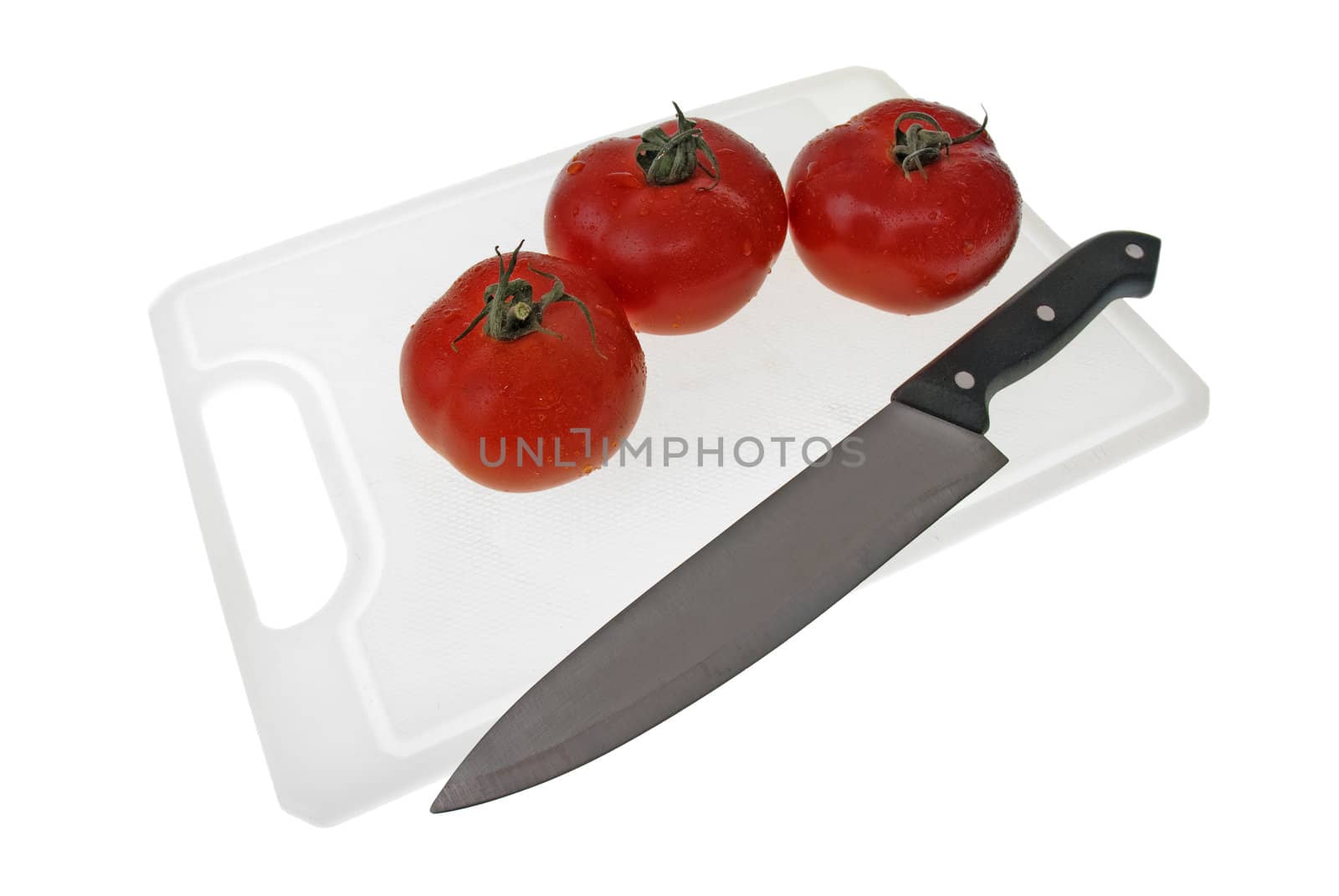 Cutting board with a knife and tomato isolated on a white background.