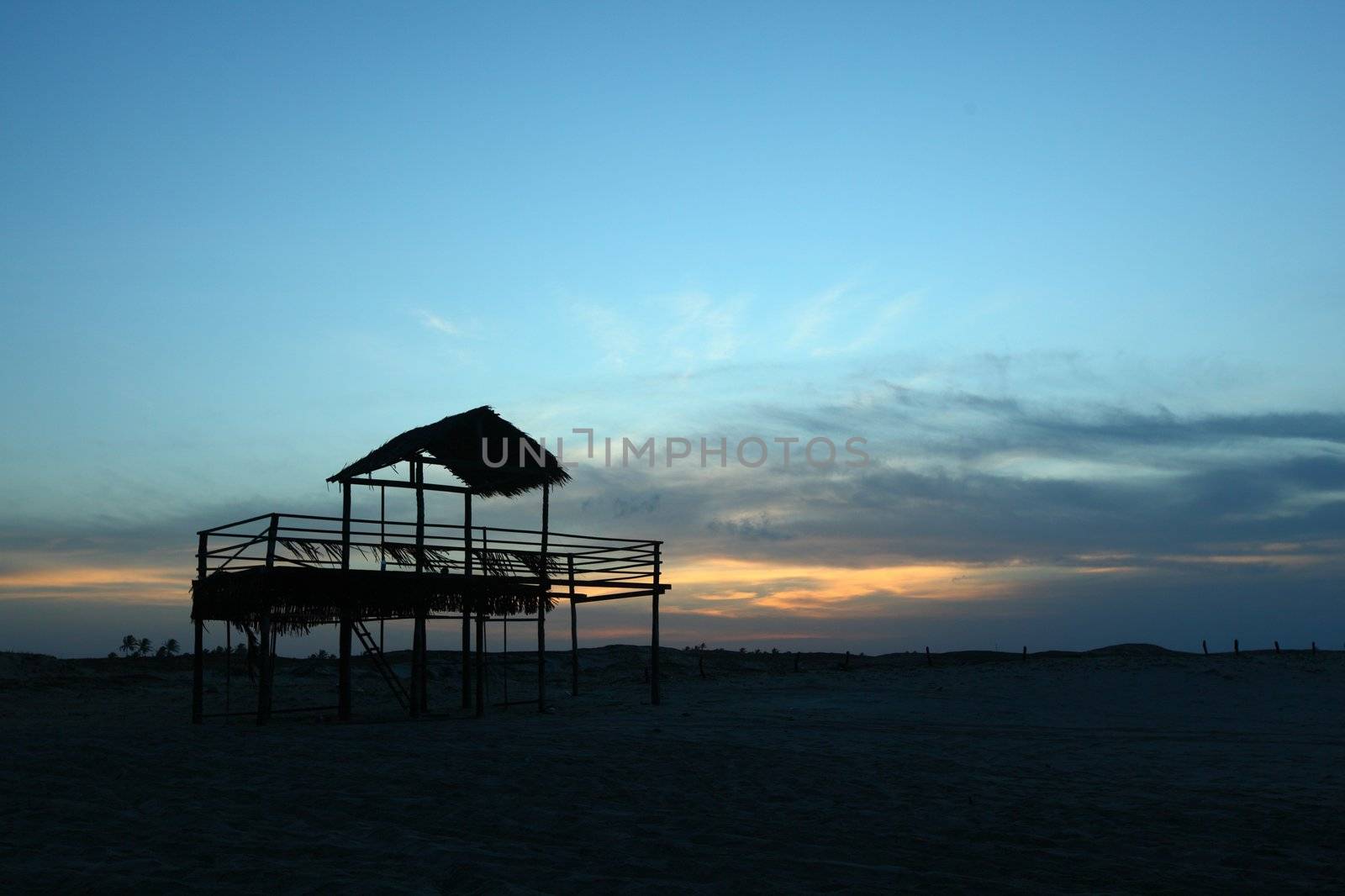 awning in sand near water